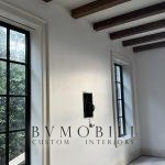 Custom wood ceiling beams installed in a bright interior
